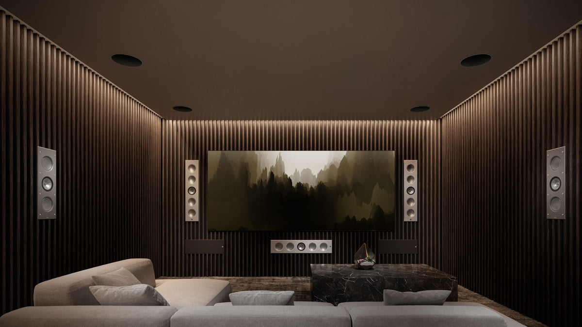 A modern home theater featuring a large screen and KEF two architectural speakers models: Ci5160RLM-THX (large) and Ci3160RLM-THX (small).
