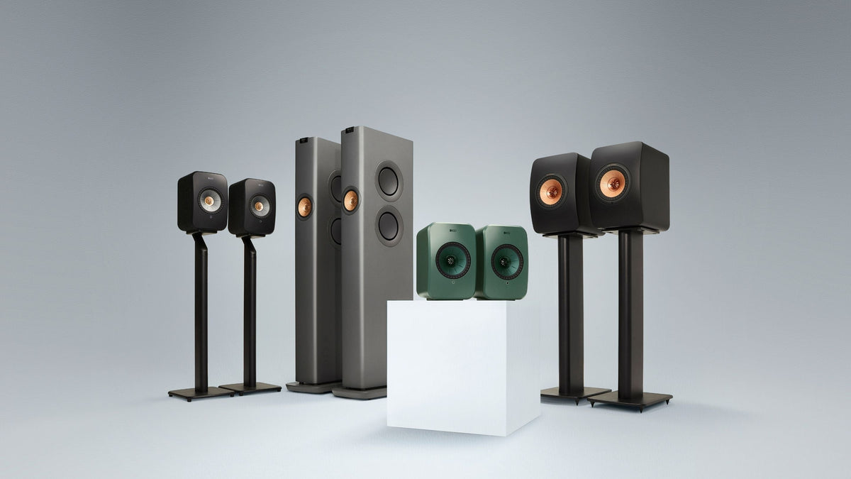 Set of KEF LS Wireless speakers on stands against a grey background